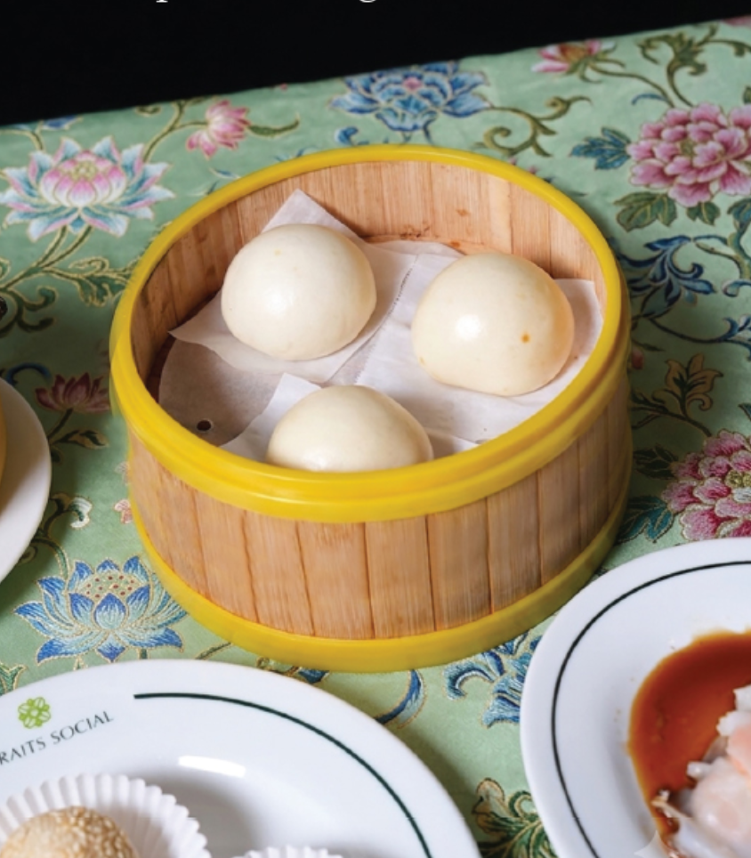 Bakpau Kacang Merah in a bamboo steamer