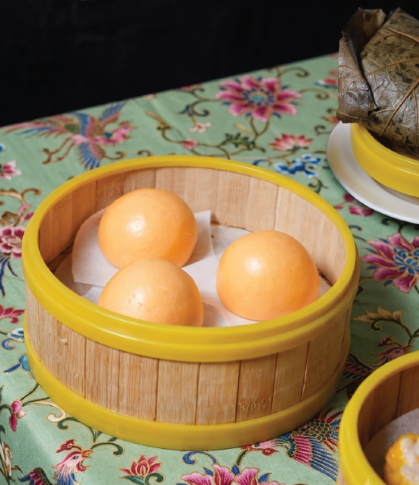 Bakpau Telor Asin in a bamboo steamer